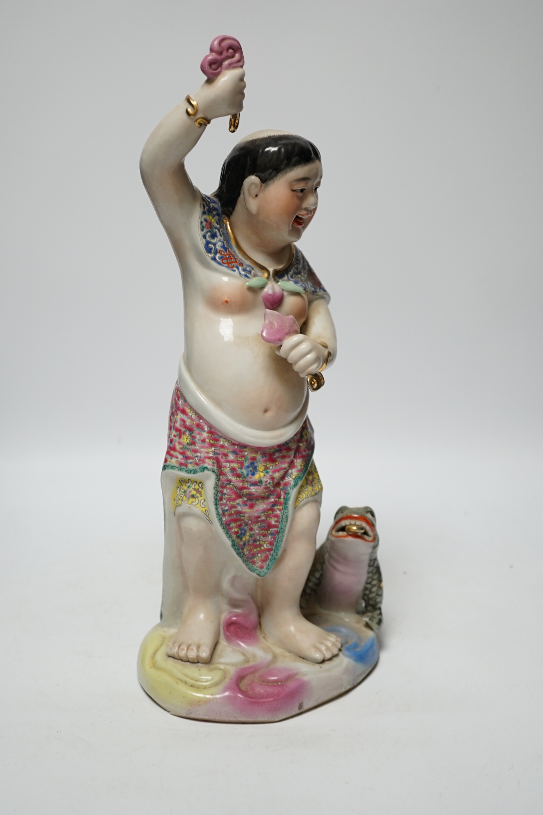 A Chinese famille rose porcelain figure of Liu Hai, stamp to base, 39cm